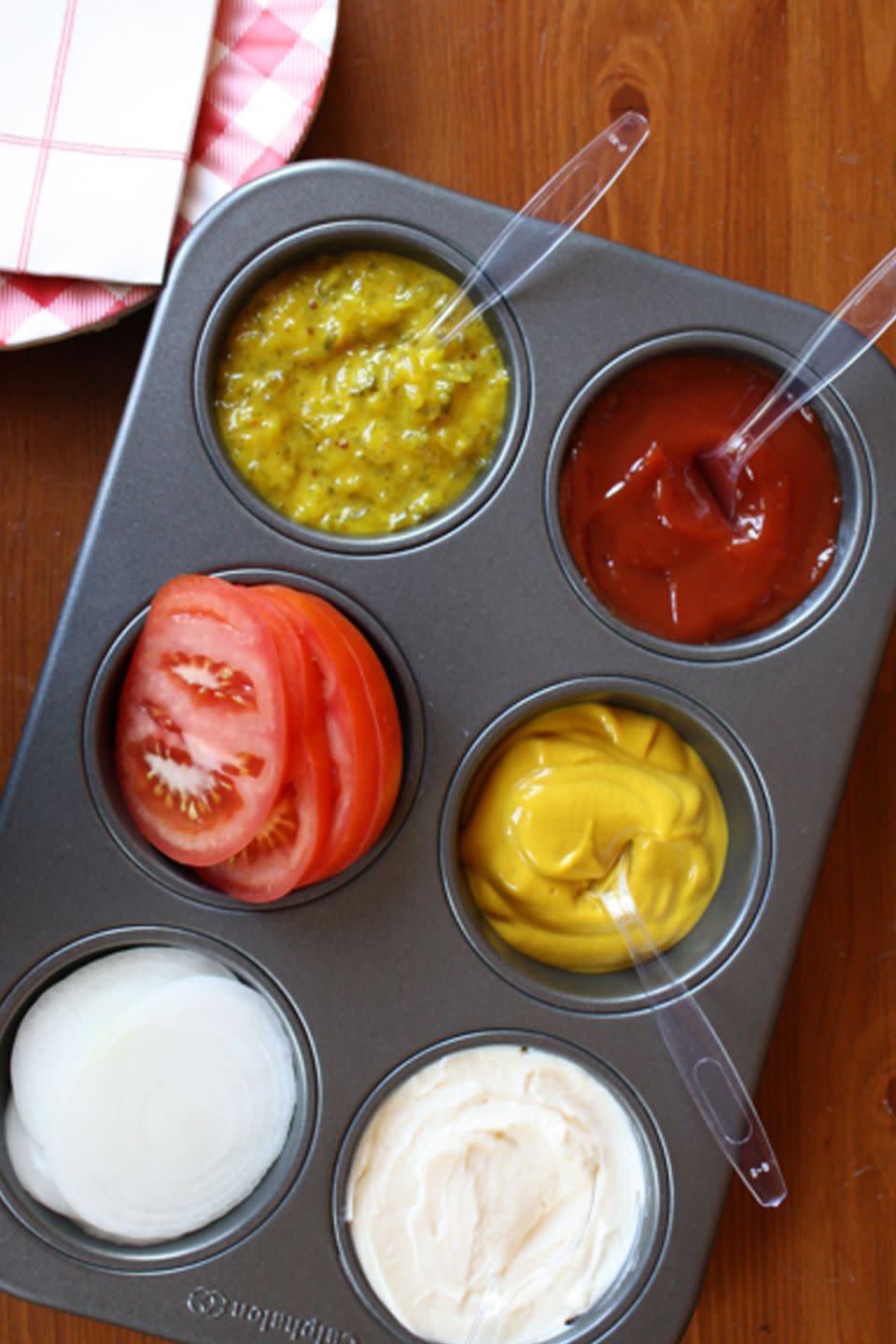 Serve condiments in a muffin tin.