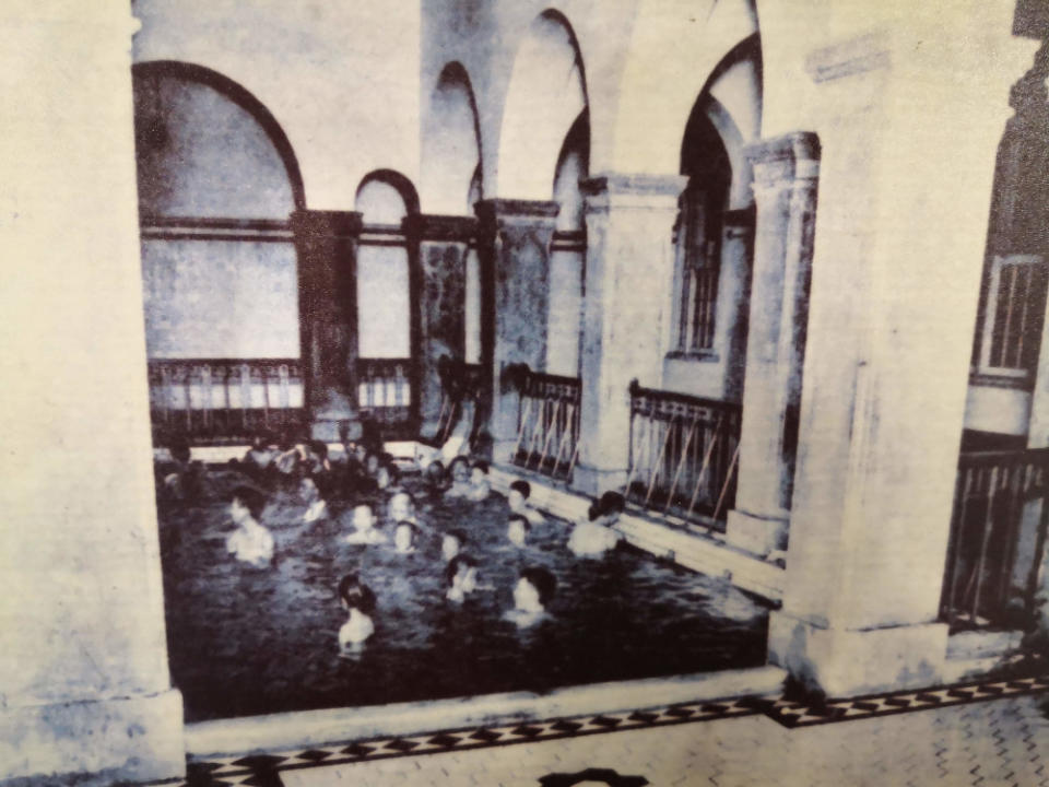 A historical photograph shows the Beitou public bathhouse in use before it was converted into a museum in Taipei, Taiwan.