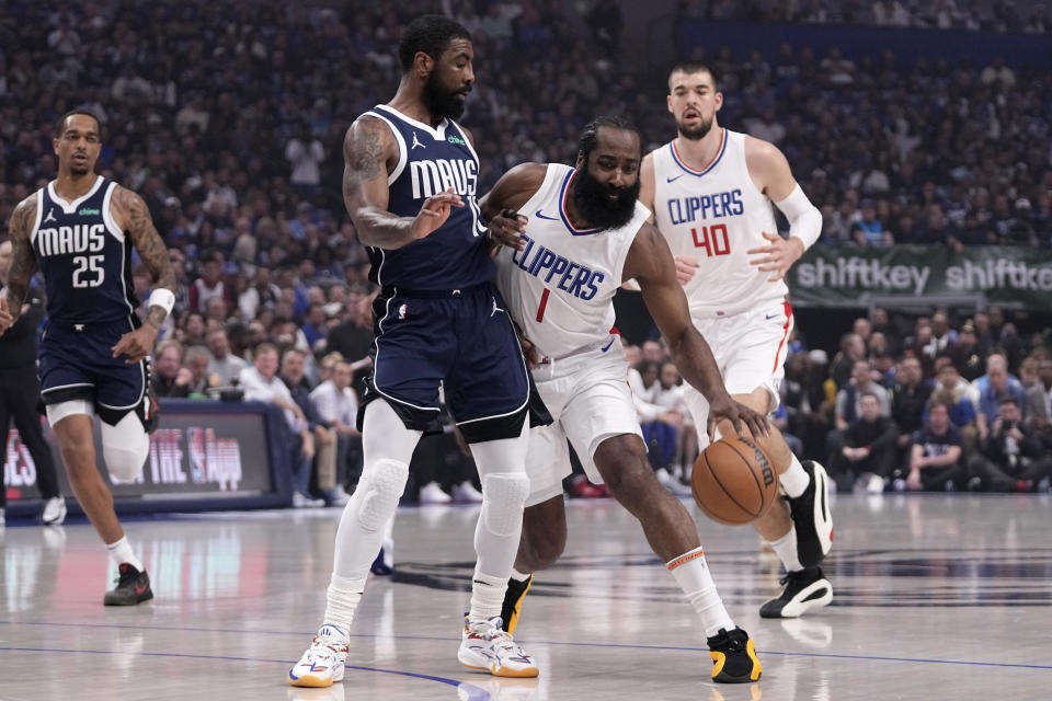 Los Angeles Clippers' James Harden (1) works around Dallas Mavericks guard Kyrie Irving during the first half of Game 2 of an NBA basketball first-round playoff series Friday, April 26, 2024, in Dallas. (AP Photo/Tony Gutierrez)