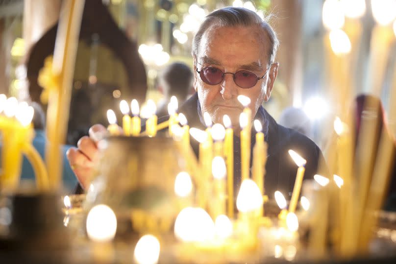 An Orthodox Bosnian Serb man lights candles during an Easter service in the Orthodox church in Sarajevo, Bosnia, on Sunday, 5 May.