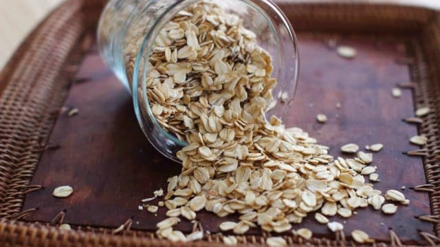 Rolled oats spill out of a container.