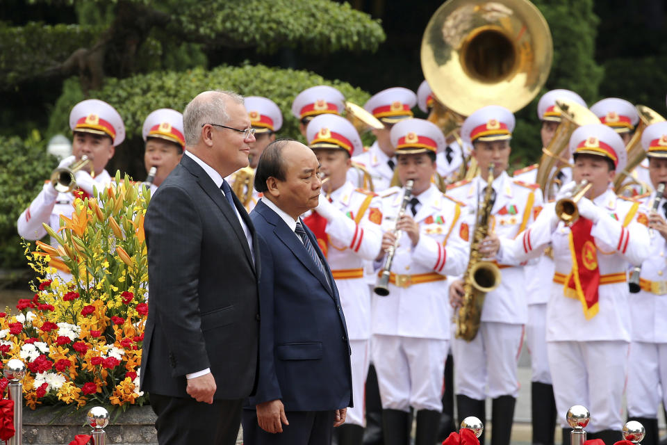 Australian Prime Minister Scott Morrison, left, with his Vietnamese counterpart Nguyen Xuan Phuc reviews an honor guard during a welcome ceremony at the Presidential Palace in Hanoi, Vietnam, Friday, Aug. 23, 2019. Morrison is on a three-day official visit to Vietnam. (AP Photo/Duc Thanh)
