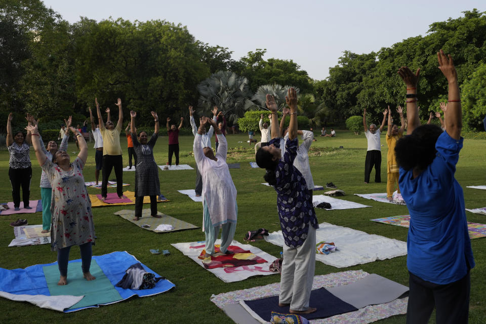 People perform yoga early morning in a park in New Delhi, India, Wednesday, June 14, 2023.India's Prime Minister Narendra Modi, known for his reputation of an ascetic, is participating in a yoga session at the U.N. during his three-day visit to the United States. Wednesday's event is aimed to raise awareness worldwide of the benefits of practicing yoga, some nine years after the Hindu nationalist leader successfully lobbied the U.N. to designate June 21 International Yoga Day. Modi has harnessed yoga as a cultural soft power to extend his nation's diplomatic reach and assert his country's rising place in the world. (AP Photo/Manish Swarup)