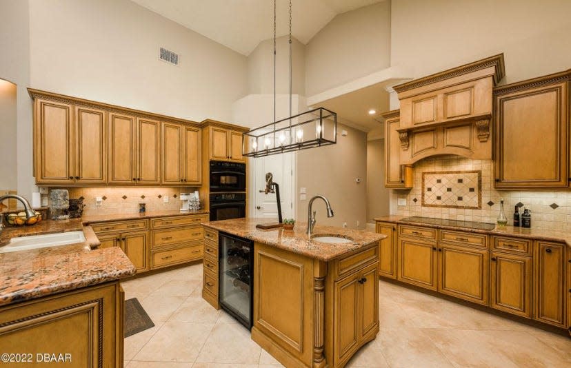 The hub of the home is this gorgeous kitchen, featuring an island with a wine fridge, a double oven, upgraded appliances, lots of storage, a breakfast bar and nook.