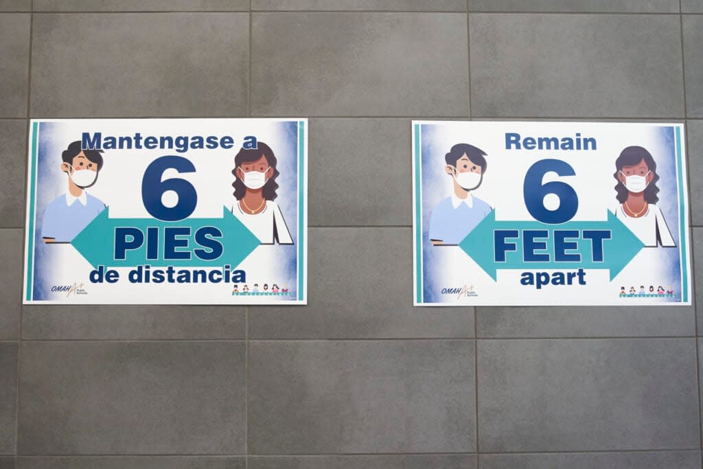 Signs on the wall remind students to keep 6 feet apart during a media tour of the Norris Middle School in Omaha, Neb., Wednesday, July 29, 2020. (AP Photo/Nati Harnik, File)