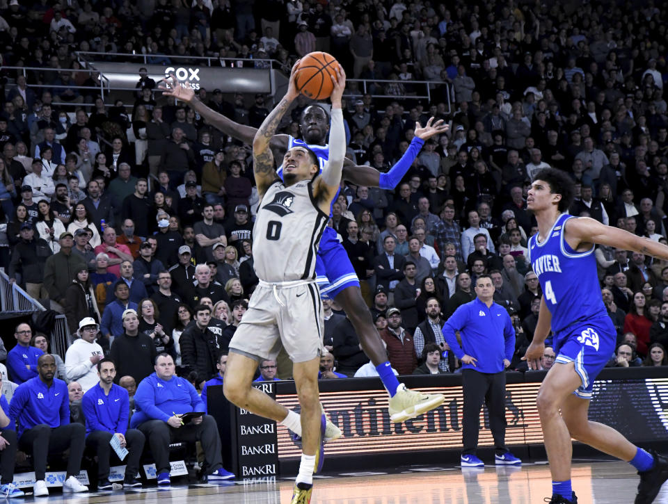 Providence guard Alyn Breed (0) scores during the first half of the team's NCAA college basketball game against Xavier, Wednesday, March 1, 2023, in Providence, R.I. (AP Photo/Mark Stockwell)