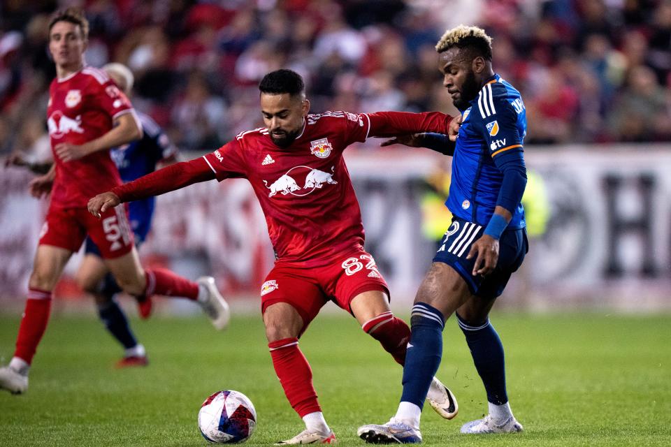 New York Red Bulls midfielder Luquinhas (82) handles the ball as FC Cincinnati forward Aaron Boupendza (9) defends in the second half of the MLS playoff match between the New York Red Bulls and FC Cincinnati at Red Bull Arena in Harrison, N.J., on Saturday, Nov. 4, 2023.