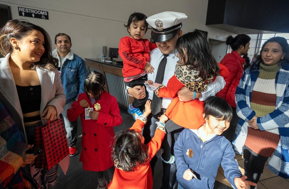 Prakash Poudyel is swarmed by his nieces, nephews and other family members following his swearing-in as a new Columbus police officer on Friday at the 138th recruit graduating class at the James G. Jackson Columbus Police Academy. Poudyel is the second Nepali police officer on the Columbus force.