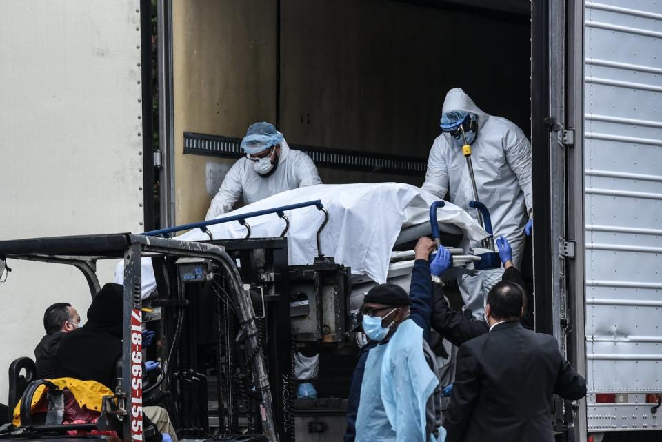 <span class="caption">Because of COVID-19, hospitals had to use refrigerated trucks as temporary morgues. Here, medical workers remove a body from one of those trucks outside Brooklyn Hospital in New York City.</span> <span class="attribution"><a class="link " href="https://www.gettyimages.com/detail/news-photo/medical-workers-remove-a-body-from-a-refrigerated-truck-news-photo/1208727616?adppopup=true" rel="nofollow noopener" target="_blank" data-ylk="slk:Getty Images / Stephanie Keith;elm:context_link;itc:0;sec:content-canvas">Getty Images / Stephanie Keith</a></span>