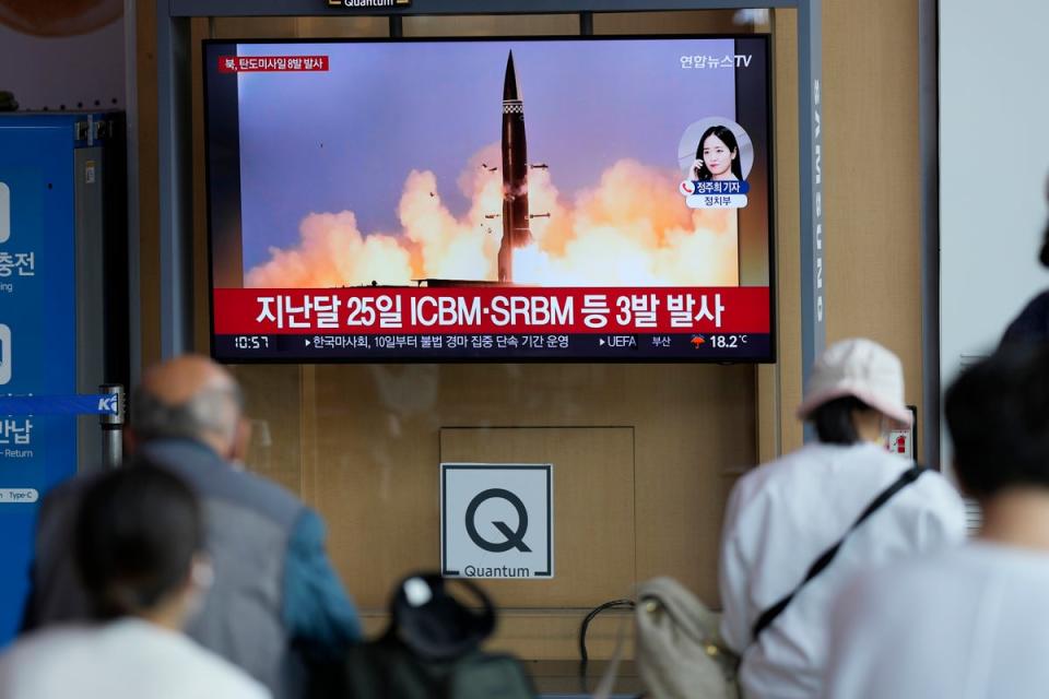 People watch a TV screen showing a news program reporting about North Korea's missile launch (Copyright 2022 The Associated Press. All rights reserved)