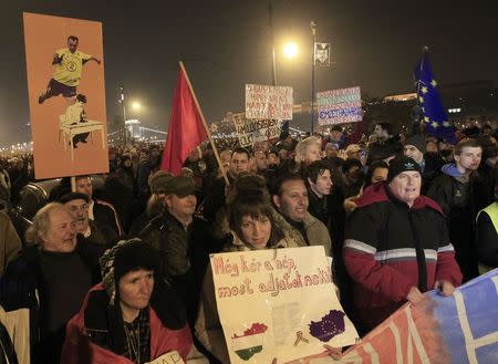 People walk during a demonstration of protest, called by civil groups, against austerity measures, corruption and general economic hardship, in Budapest, December 16, 2014. REUTERS/Bernadett Szabo