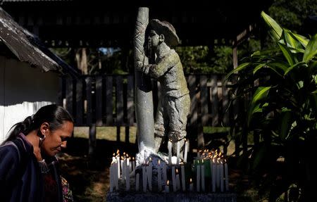 A devotee prays in front of a statue of Sao Joao do Guarani (Saint Joao of Guarani) during an annual celebration in Chico Mendes Extraction Reserve in Xapuri, Acre state, Brazil, June 24, 2016. REUTERS/Ricardo Moraes