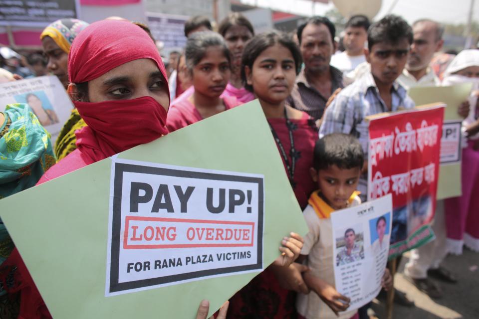 Relatives of victims who were killed or went missing in the Rana Plaza collapse protest on the first year anniversary of the accident, as they gather in Savar April 24, 2014. Protesters and family members of victims demand compensation on the one year anniversary of the collapse of Rana Plaza, in which more than 1,100 factory workers were killed and 2,500 others were injured.