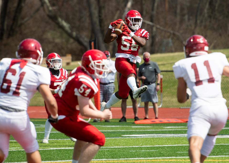 St. John's Sebastien Romain catches a pass during a game against Fitchburg on Saturday, April 10, 2021.