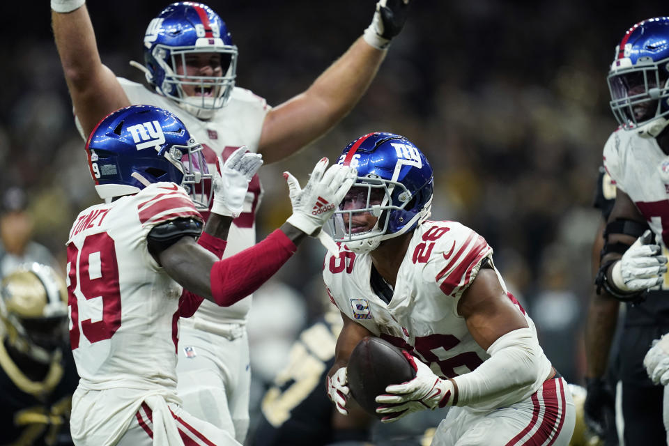 New York Giants running back Saquon Barkley (26) celebrates his touchdown in overtime with wide receiver Kadarius Toney (89) to defeat the New Orleans Saints 27-21, during an NFL football game in New Orleans, Sunday, Oct. 3, 2021. (AP Photo/Brett Duke)