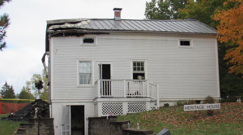 Significant damage was sustained by the Heritage House in Silver Springs Park in Stow. To the left, debris is shoveled and tossed out a first-floor window.