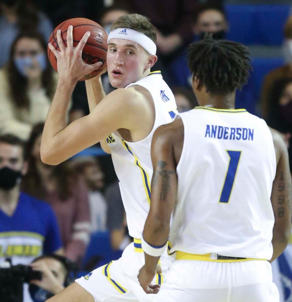 Delaware's Andrew Carr grabs a rebound in front of teammate Kevin Anderson in the first half of Delawares win against Lafayette at the Bob Carpenter Center, Wednesday, Dec. 8, 2021.