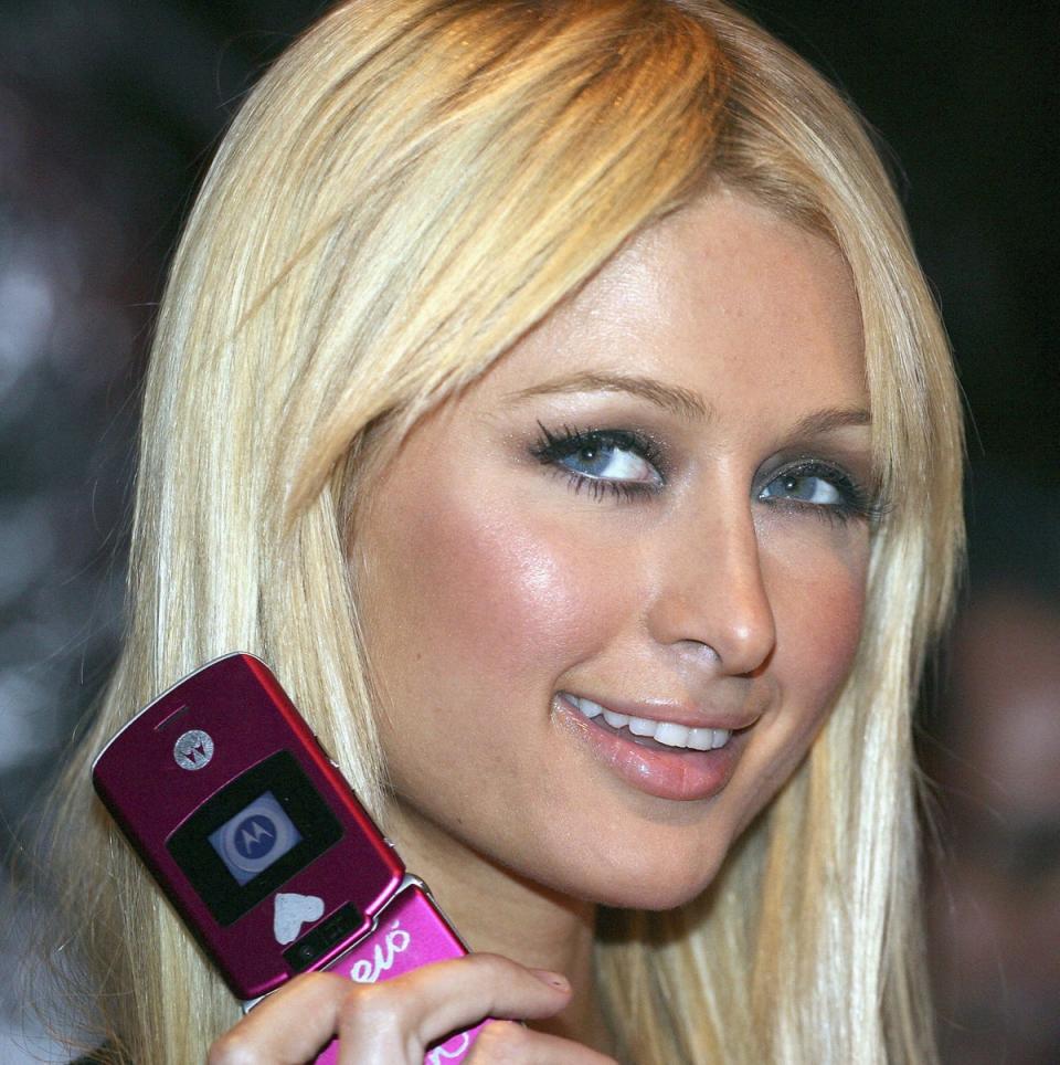 Queen of the flip phone, Paris Hilton, with her Motorola device in 2006 (Getty Images)