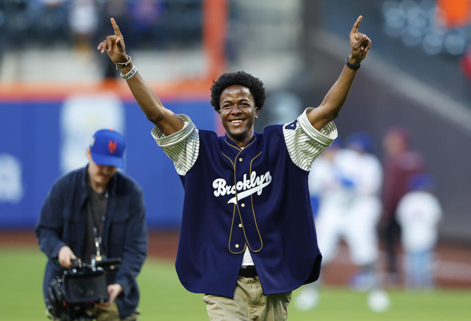 Busaro Robinson, grandson of Jackie Robinson, reacts after throwing the ceremonial first pitch on Jackie Robinson Day before a baseball game between the New York Mets and the Pittsburgh Pirates Monday, April 15, 2024, in New York. (AP Photo/Noah K. Murray)