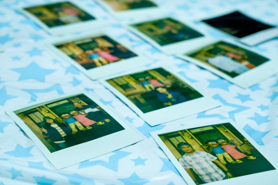 Polaroid pictures of families with 6-year-old Rohingya twin characters Aziz and Noor prior to the viewing of Sesame Street in the Rohingya language Saturday, Oct. 15, 2022, at the Burmese Rohingya Community of Wisconsin in Milwaukee.