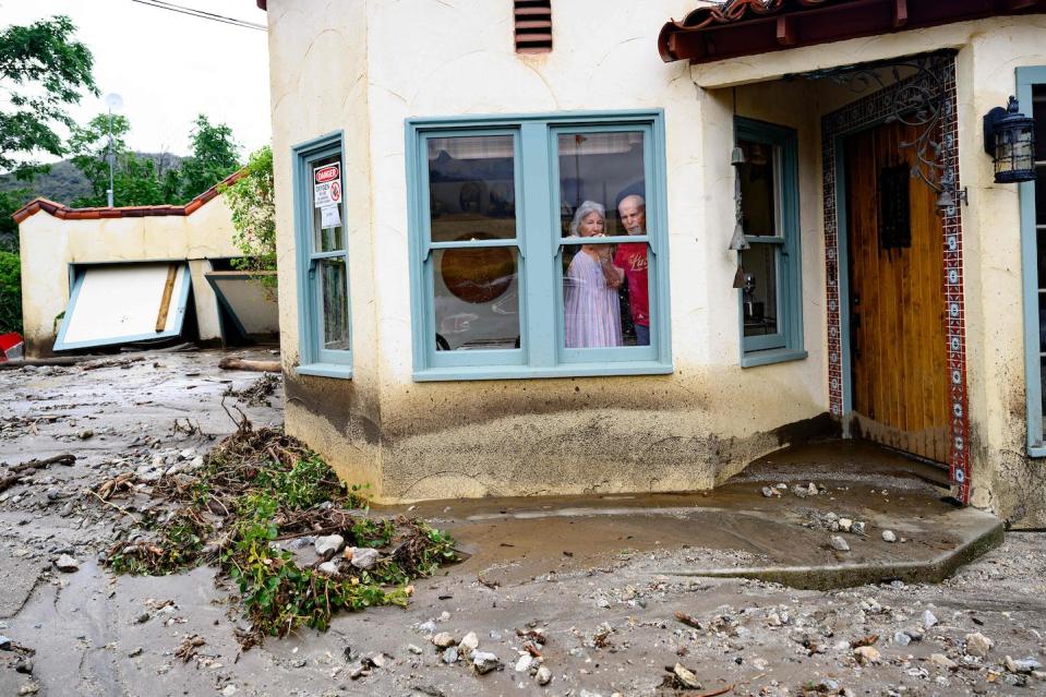 Tropical Storm Hilary flooded several areas in Southern California, stranding people for days. <a href="https://www.gettyimages.com/detail/news-photo/residents-trapped-in-their-home-peer-out-a-window-while-news-photo/1614093982" rel="nofollow noopener" target="_blank" data-ylk="slk:Josh Edelson/AFP via Getty Images;elm:context_link;itc:0;sec:content-canvas" class="link ">Josh Edelson/AFP via Getty Images</a>