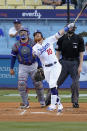 Los Angeles Dodgers' Justin Turner, center, hits a solo home run as Texas Rangers catcher Jose Trevino watches along with home plate umpire Nic Lentz during the first inning of a baseball game Friday, June 11, 2021, in Los Angeles. (AP Photo/Mark J. Terrill)