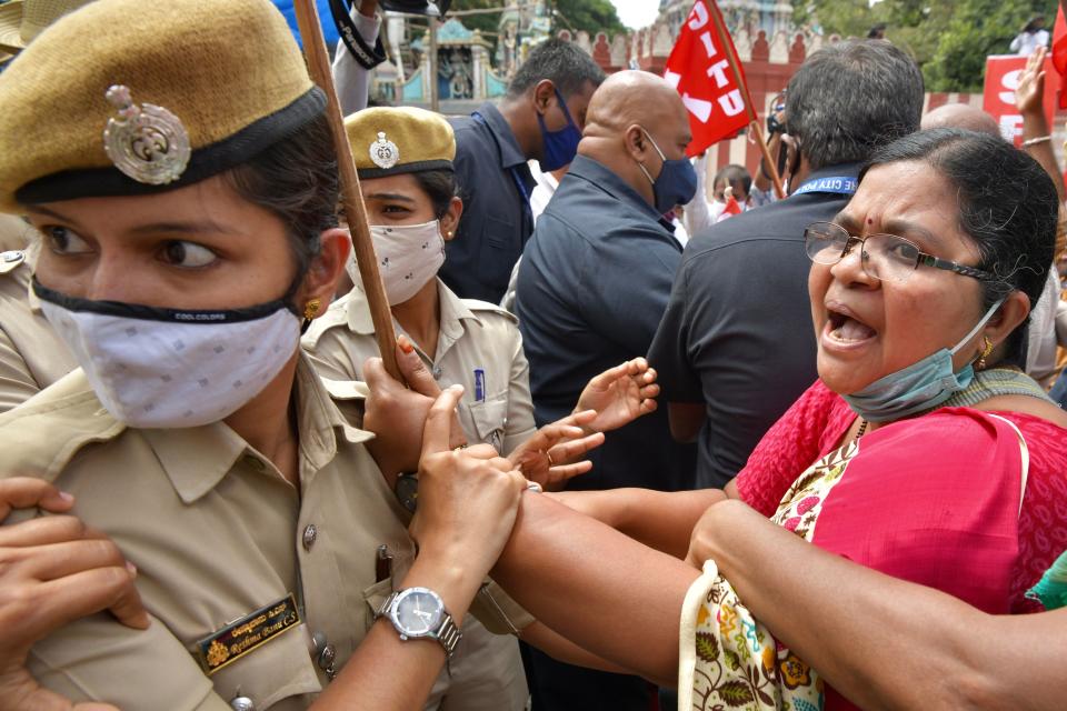 Police personnel detain an activist from a farmers rights organisation during a protest following the recent passing of agriculture bills in the Lok Sabha (lower house), in Bangalore on September 25, 2020. (Photo by Manjunath Kiran / AFP) (Photo by MANJUNATH KIRAN/AFP via Getty Images)