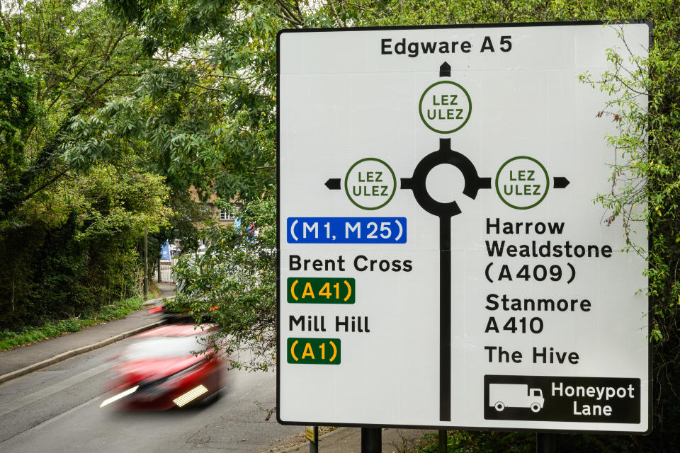 LONDON, ENGLAND - AUGUST 29: A road sign with added information indicating the expanded LEZ and ULEZ boundary is seen on August 29, 2023 in London, England. August 29 is the first day of the London-wide Ultra Low Emission Zone (ULEZ) expansion to all of Greater London, a policy designed to reduce air pollution by imposing charges on drivers of older, more polluting vehicles. The new rules have sparked political backlash in some parts of London and neighbouring counties. (Photo by Leon Neal/Getty Images)