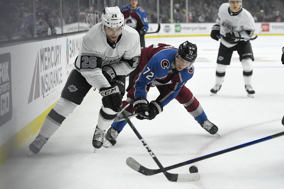 Los Angeles Kings defenseman Sean Walker, left, and Colorado Avalanche right wing Joonas Donskoi battle for the puck during the first period of an NHL hockey game Saturday, Feb. 22, 2020, in Los Angeles. (AP Photo/Mark J. Terrill)