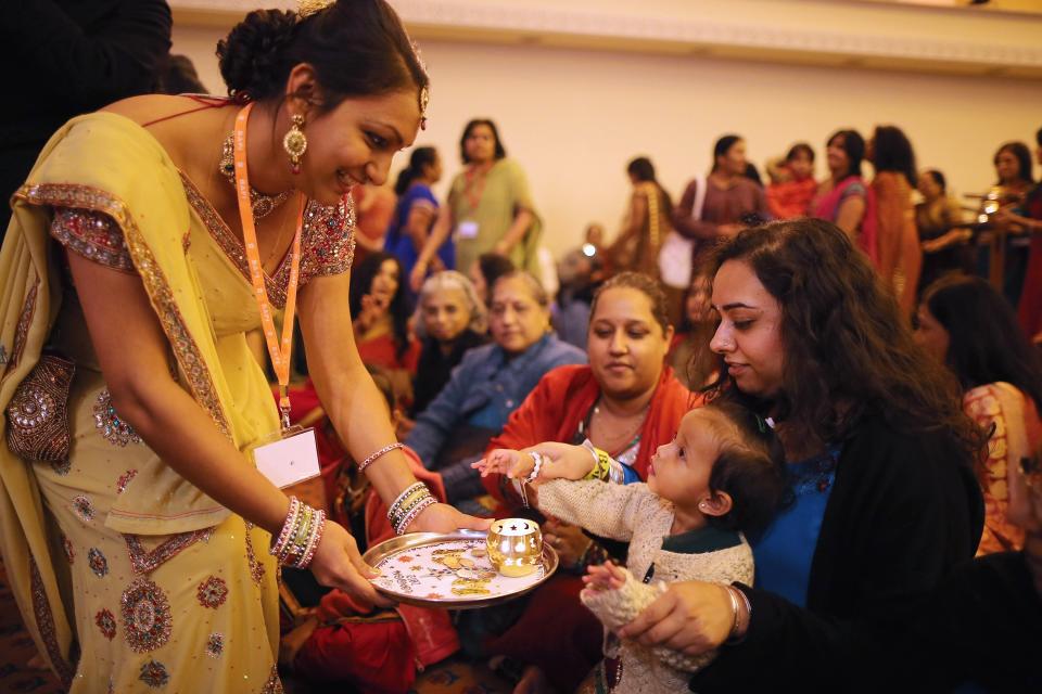 LONDON, ENGLAND - NOVEMBER 14: Scented candles are taken to wellwishers during a ceremony as Sadhus and Hindus celebrate Diwali at the BAPS Shri Swaminarayan Mandir on November 14, 2011 in London, England. Diwali, which marks the start of the Hindu New Year, is being celebrated by thousands of Hindu men women and children in the Neasden mandir, which was the first traditional Hindu temple to open in Europe. (Photo by Dan Kitwood/Getty Images)