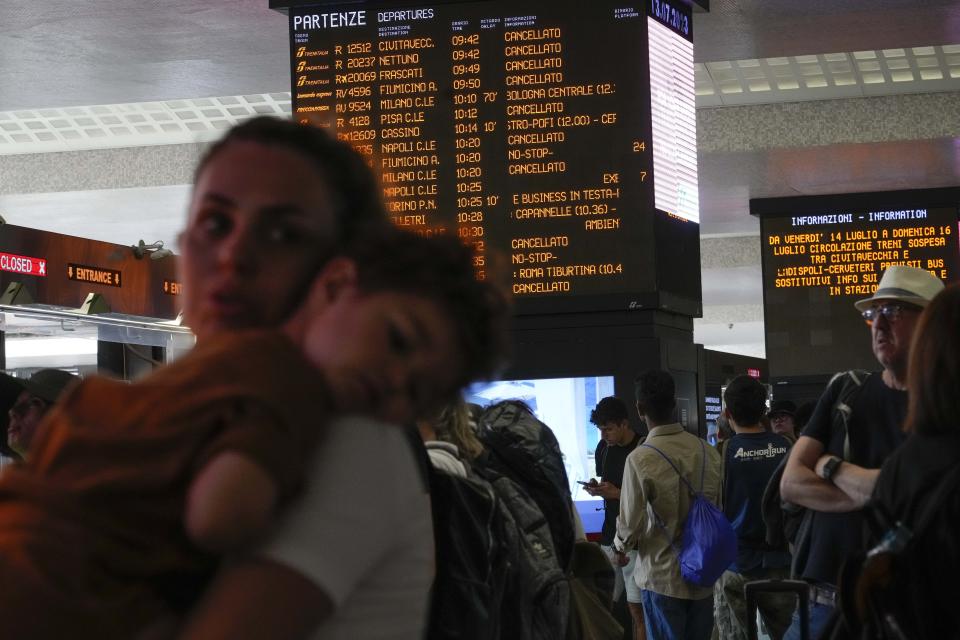 Passengers wait for their trains at Rome's termini central station during a national train strike, Thursday, July 13, 2023. Trenitalia and Italo train workers are on strike to demand better working conditions and training. (AP Photo/Gregorio Borgia)