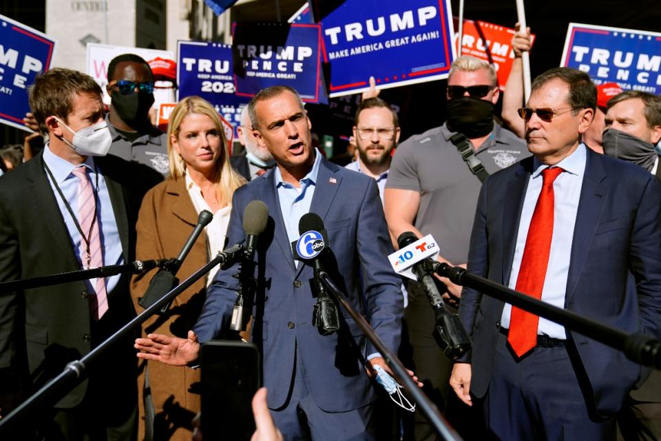 Corey Lewandowski, center, speaks outside the Pennsylvania Convention Center Thursday, Nov. 5, 2020, in Philadelphia. At left is Pam Bondi. 