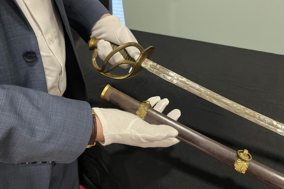 Adam Fleischer, President of Fleischer's Auctions, holds Civil War Union Gen. William Tecumseh Sherman's sword and scabbard, Thursday, May 9, 2024, in Columbus, Ohio. The wartime sword, likely used between 1861 and 1863, are among the items that will be open to bidders Tuesday, May 14, 2024, at Fleischer’s Auctions. (AP Photo/Patrick Orsagos)