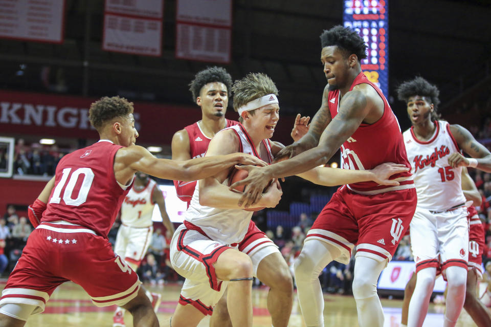 Rutgers guard Paul Mulcahy (4) tries to move the ball between Indiana guard Rob Phinisee (10) and forward De'Ron Davis (20) during the first half of an NCAA college basketball game, Wednesday, Jan. 15, 2020 in Piscataway, N.J. (Andrew Mills/NJ Advance Media via AP)