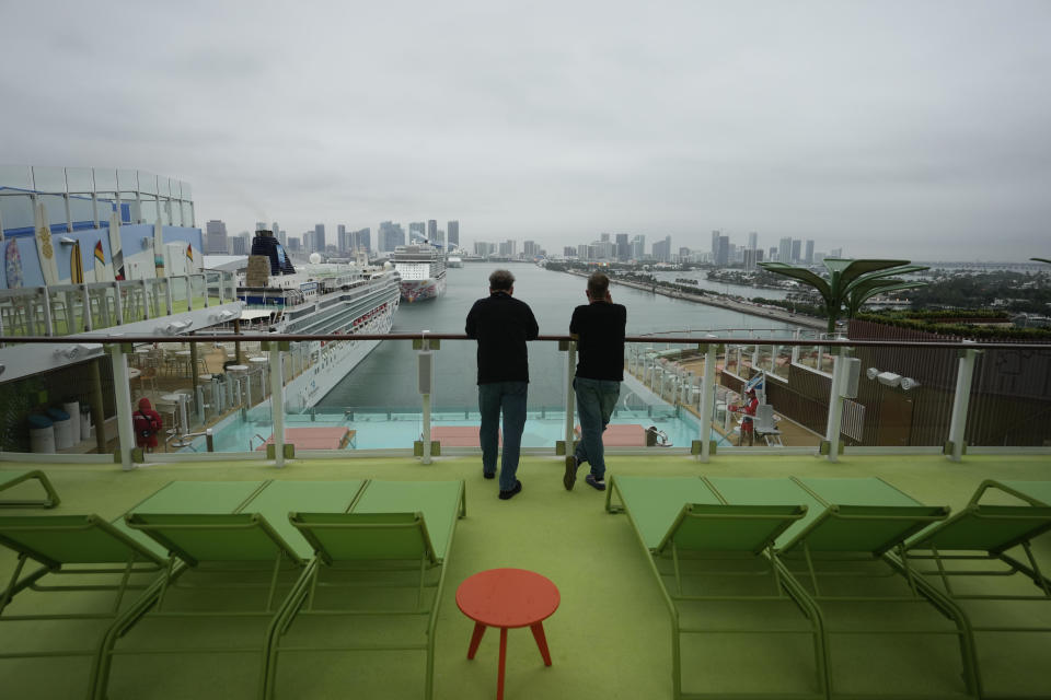 Employees look toward the Miami skyline from the deck of Icon of the Seas, the world's largest cruise ship, during a media day preview as it prepares for its inaugural public voyage later this month, Thursday, Jan. 11, 2024, at PortMiami in Miami. / Credit: Rebecca Blackwell / AP