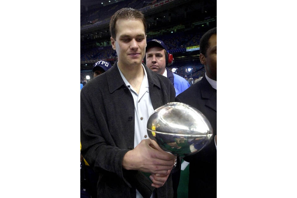 FILE - New England Patriots quarterback Tom Brady holds the Super Bowl trophy after the Patriots beat the St. Louis Rams 20-17 in Super Bowl XXXVI at the Louisiana Superdome, Sunday, Feb. 3, 2002, in New Orleans. Tom Brady has retired after winning seven Super Bowls and setting numerous passing records in an unprecedented 22-year-career. He made the announcement, Tuesday, Feb. 1, 2022, in a long post on Instagram. (AP Photo/Doug Mills)