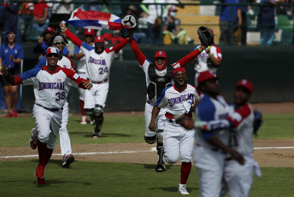 Dominican Republic players celebrate after their 8-5 victory over Venezuela in a final Olympic baseball qualifier game, in Puebla, Mexico, Saturday, June 26, 2021. (AP Photo/Fernando Llano)