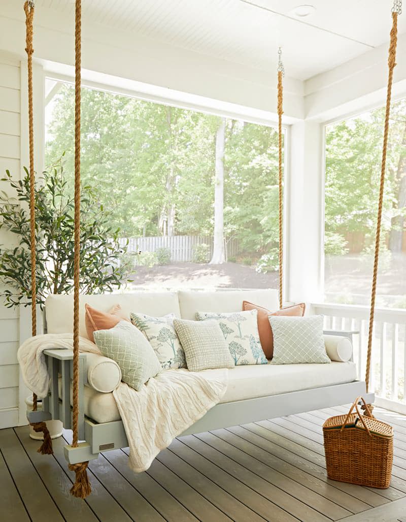 Swinging chair on screened in patio.