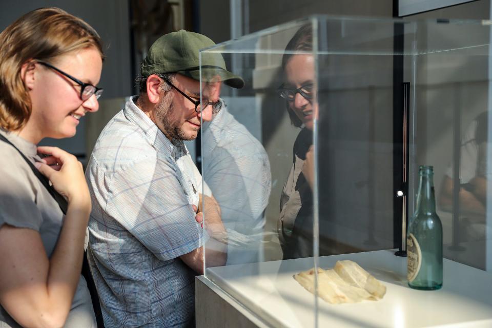 Stephanee Borger, 41, of Oak Park, and Adam Sekuler, 46, of Detroit, look at the message in a bottle display while touring the first floor of Michigan Central Station in Detroit on Friday, June 22, 2024.