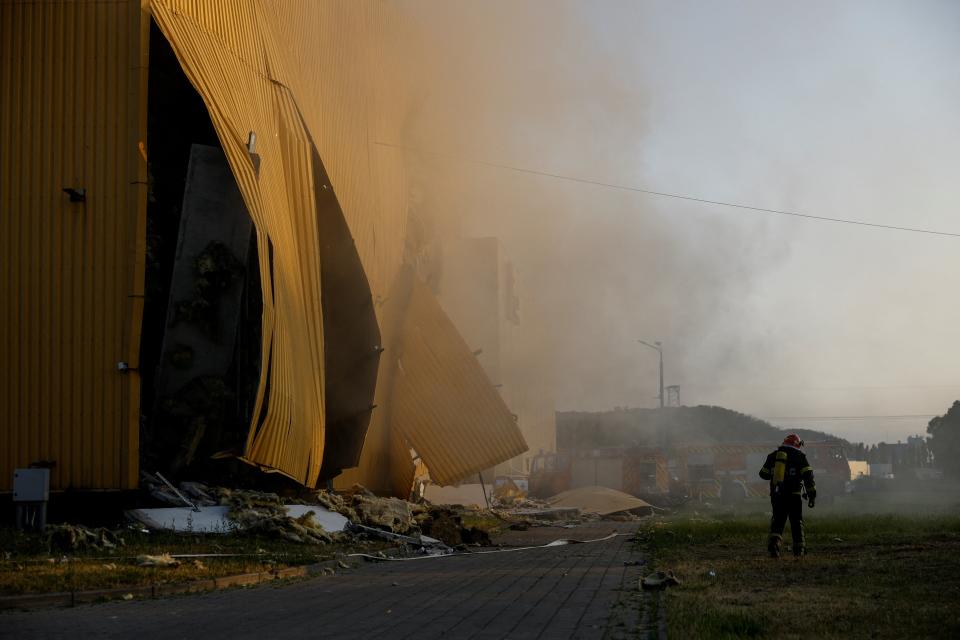 A firefighter works at a site of a tobacco factory damaged during Russian suicide drone strike, amid Russia’s attack on Ukraine, in Kyiv, Ukraine 28 May 2023 (Reuters)