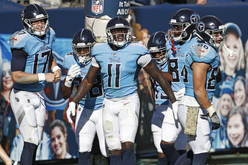 Tennessee Titans wide receiver A.J. Brown (11) celebrates with quarterback Ryan Tannehill (17) after they teamed up for a 40-yard touchdown pass. (AP Photo/Wade Payne)