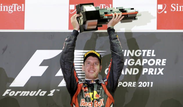 Renault Red Bull's Sebastian Vettel hoists his winning trophy aloft. (Photo: Reuters)