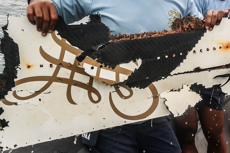 A member of the Indonesian navy divers personnel shows debris recovered from the sea where the Sriwijaya Air flight SJ 182 crashed during search and rescue operation at the Java sea in Jakarta