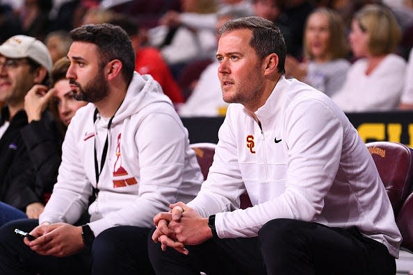 USC football head coach Lincoln Riley looks on with Executive Senior Associate Athletic Director Brandon Sosna during the college basketball game between the Arizona Wildcats and the USC Trojans on March 1, 2022 at Galen Center in Los Angeles, CA.