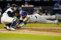 Kansas City Royals Carlos Santana (41) dives ahead of the tag by New York Yankees catcher Kyle Higashioka during the eighth inning of a baseball game, Tuesday, June 22, 2021, at Yankee Stadium in New York. (AP Photo/Kathy Willens)