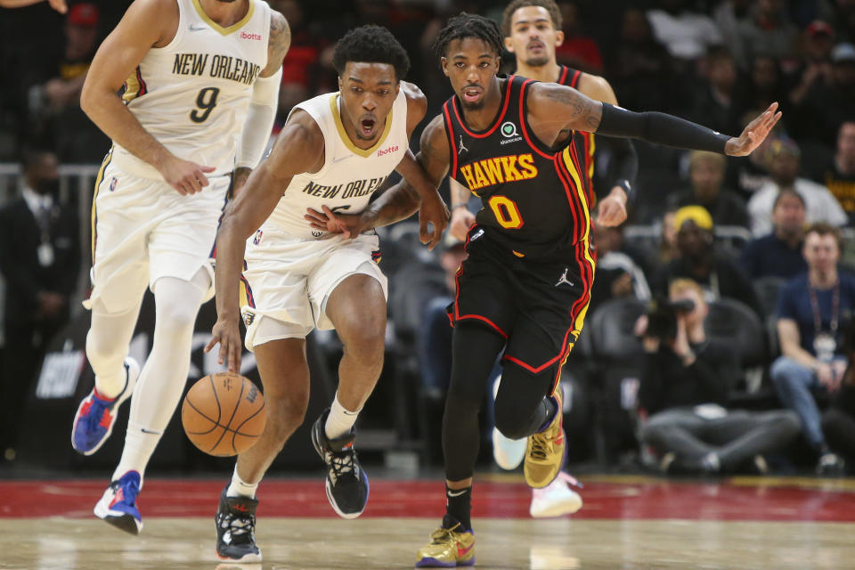 New Orleans Pelicans forward Herbert Jones (5) is defended by Atlanta Hawks guard Delon Wright (0) in the first half of an NBA basketball game Sunday, March 20, 2022, in Atlanta, Ga. (AP Photo/Brett Davis)