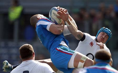 Italy's Tito Tebaldi (L) is tackled by England's Jack Nowell during their Six Nations rugby union match at Olympic Stadium in Rome, March 15, 2014. REUTERS/Alessandro Bianchi