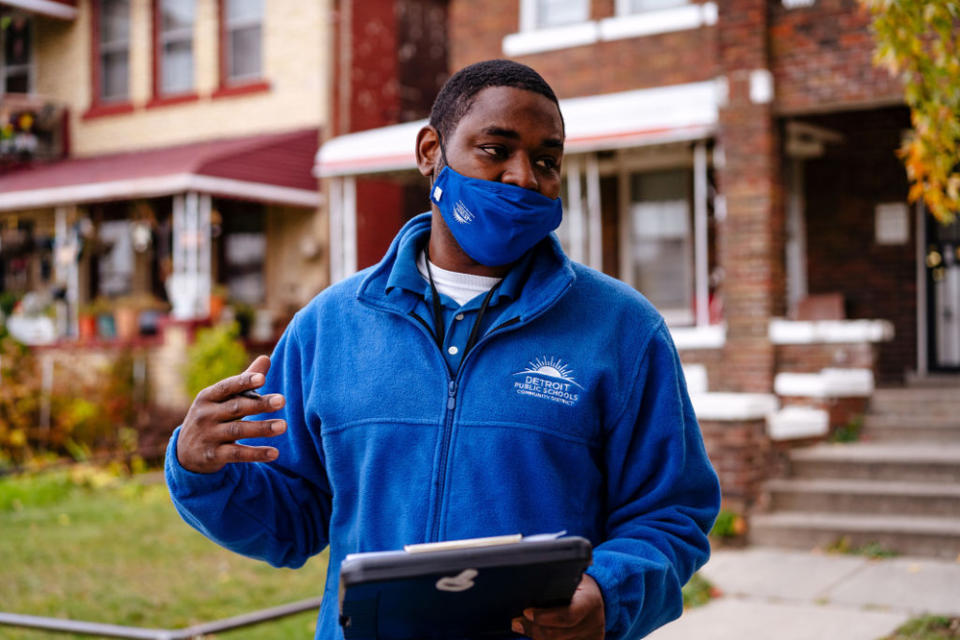 A DPSCD employee goes door to door in October 2020 to help families access virtual learning. (Nick Hagen/Getty Images)