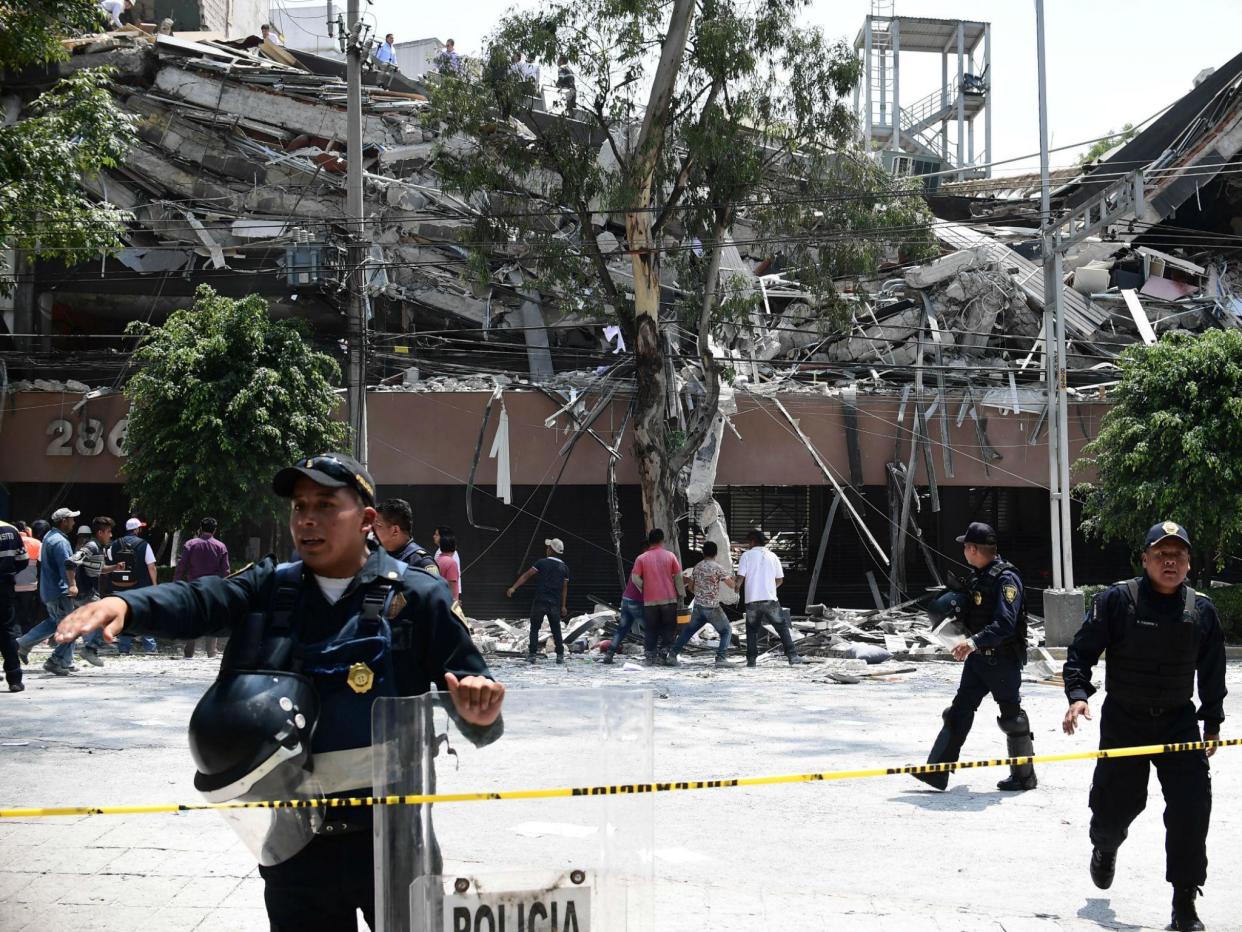 An injured woman is pictured in Mexico City after a 7.1 magnitude earthquake: RONALDO SCHEMIDT/AFP/Getty Images