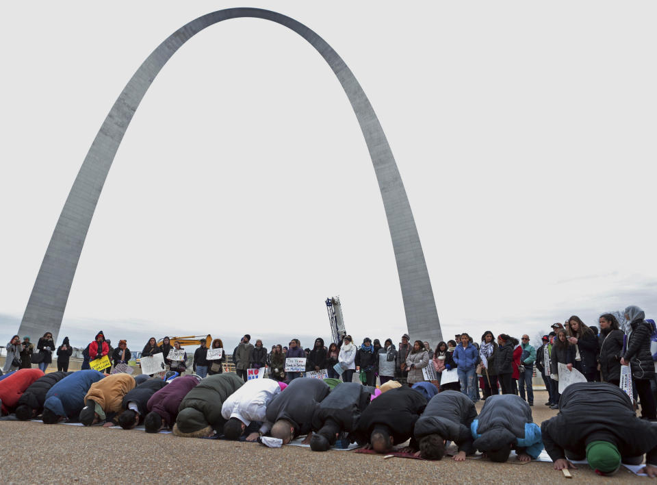 FILE - In this Saturday, Feb. 4, 2017 file photo, Muslim worshippers pray near the Gateway Arch after a march in protest of President Donald Trump's executive order banning people from several Muslim-majority nations from entering the United States. (Cristina M. Fletes/St. Louis Post-Dispatch via AP)